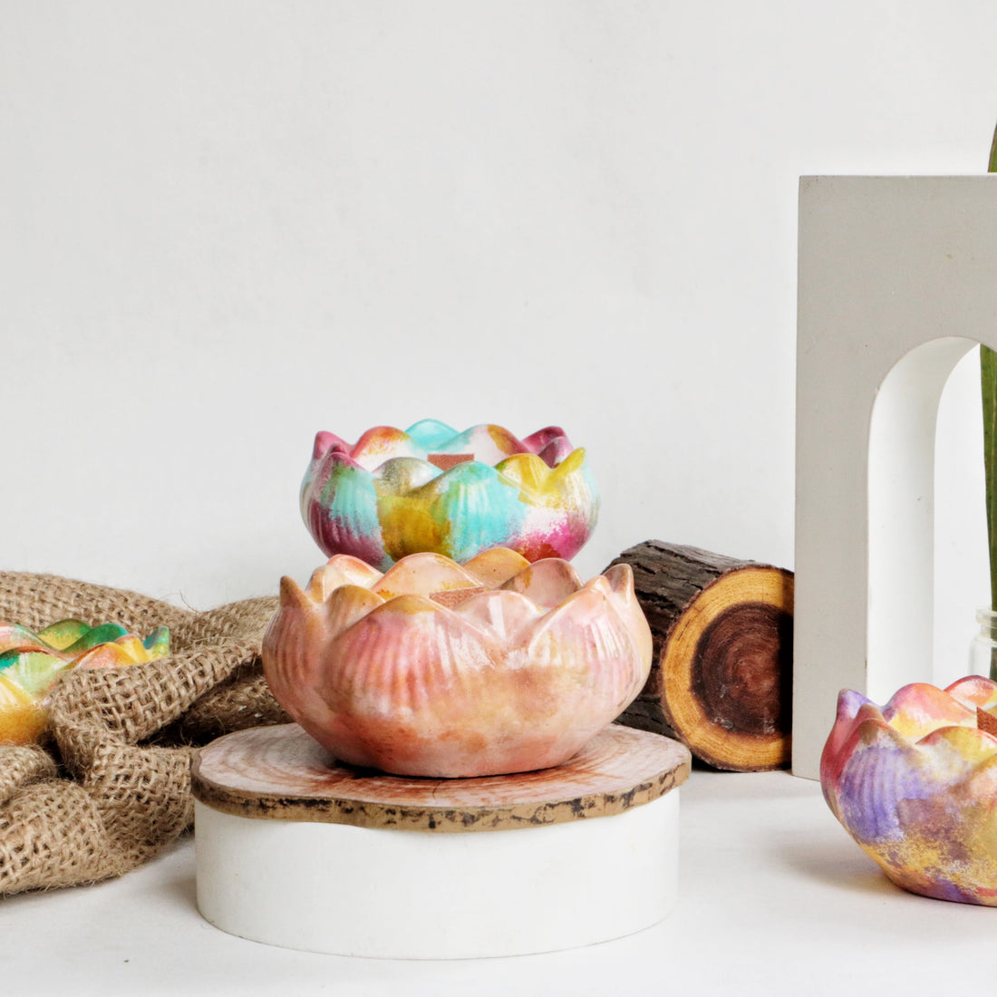 Scented candle in a jar with a burning wick, filling the room with fragrance.